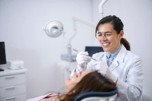 A calm dental clinic interior with a dentist in a white coat gently examining a patient's teeth using a mirror and probe, soft natural lighting, modern equipment in the background, a reassuring smile on the dentist's face, no text or symbols visible