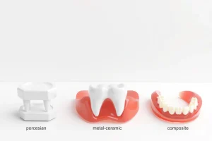 A clean, professional dental illustration showing various types of artificial teeth (crowns, bridges, implants, dentures) arranged on a white background with subtle shadows, each labeled by material type (porcelain, zirconia, metal-ceramic, acrylic, composite) using minimalist icons and soft color coding — no text, no letters, no digits, only visual symbols and shapes to represent materials and types