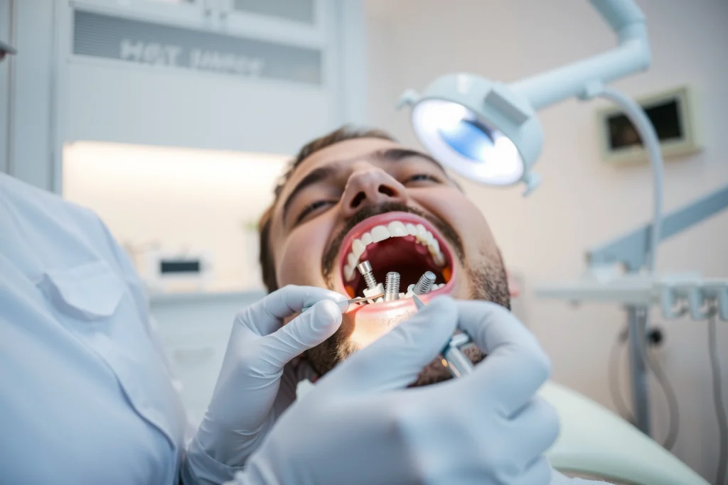 A professional dental clinic setting showing a dentist examining a patient's teeth with dental implants visible, modern dental equipment, clean white environment, focus on dental restoration process