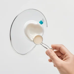 A close-up illustration of a person's hand holding a lost tooth, with a small container with milk or saline solution, and a dental mirror on a clean white background, symbolizing first aid steps for a knocked-out tooth