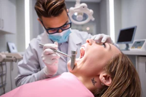 A modern dental clinic interior showing a dentist performing a dental implant procedure on a patient, with close-up view of the jawbone and titanium implant being placed, surrounded by sterile dental tools, soft ambient lighting, and a calm, professional atmosphere