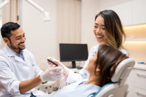 A professional dental clinic interior with a smiling dentist in a white coat examining a patient's teeth using modern dental equipment, warm lighting, clean and welcoming atmosphere, focus on trust and care
